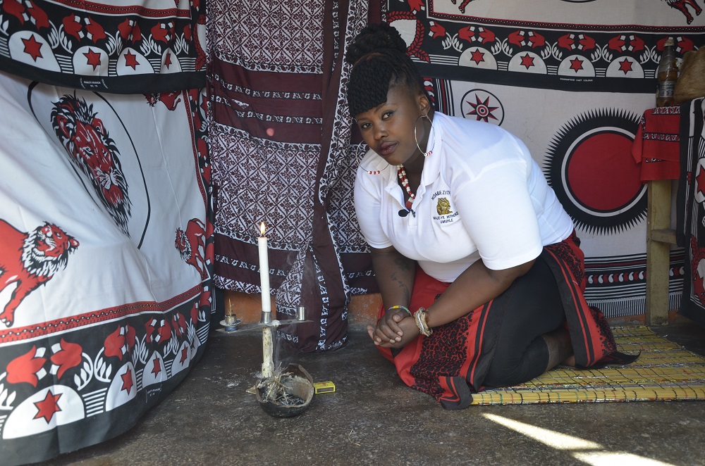 Badanile Maci, a traditional healer known as a u00e2u20acu02dcsangomau00e2u20acu2122, lights a candle and imphepho, or liquorice plant, to greet her ancestors in Katlehong, a township east of Johannesburg, South Africa June 7, 2019. u00e2u20acu201d Thomson Reuters Foundation pic
