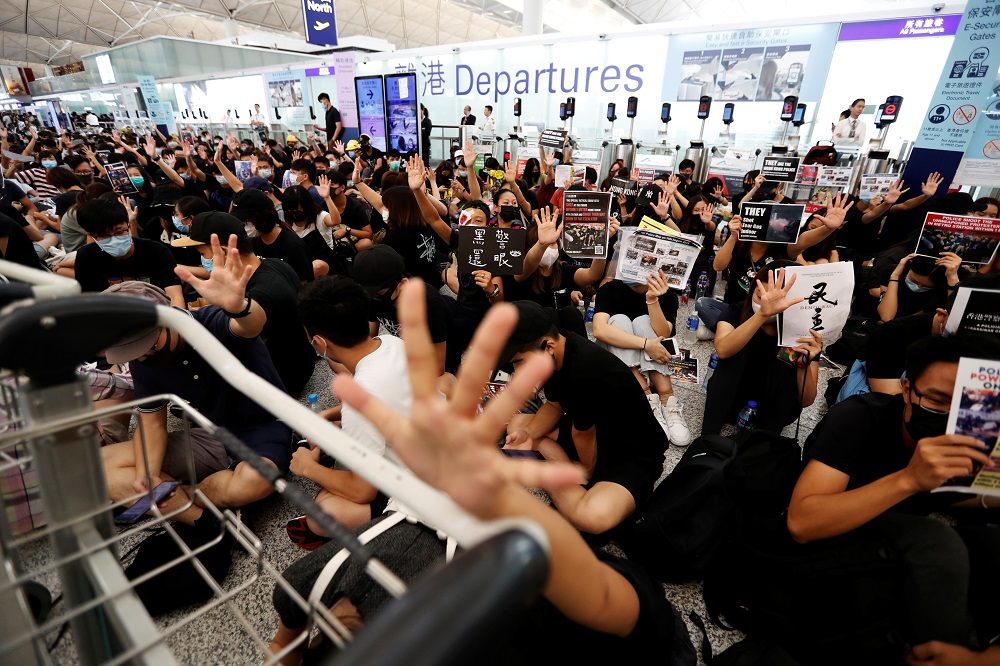 Anti-government protesters react after the announcement that all airport operations are suspended due to a demonstration at Hong Kong Airport August 13, 2019. u00e2u20acu201d Reuters pic