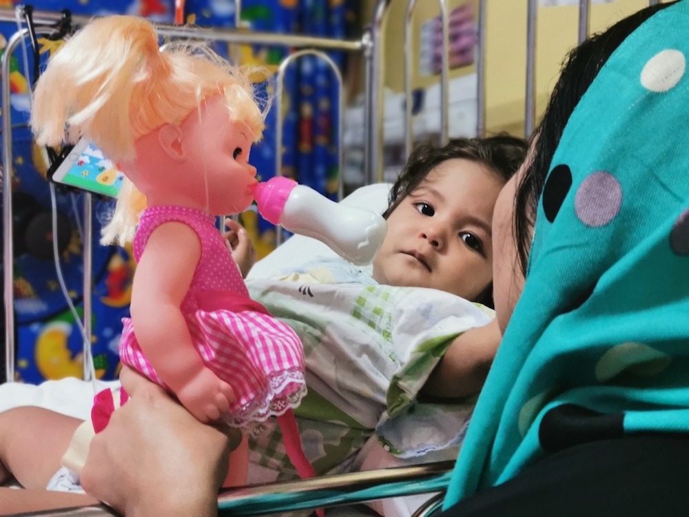 Afghan refugee girl Mahdya Mohseni, 2, who has leukaemia is seen from her hospital bed in Kuala Lumpur July 22, 2019. u00e2u20acu201d Thomson Reuters Foundation pic