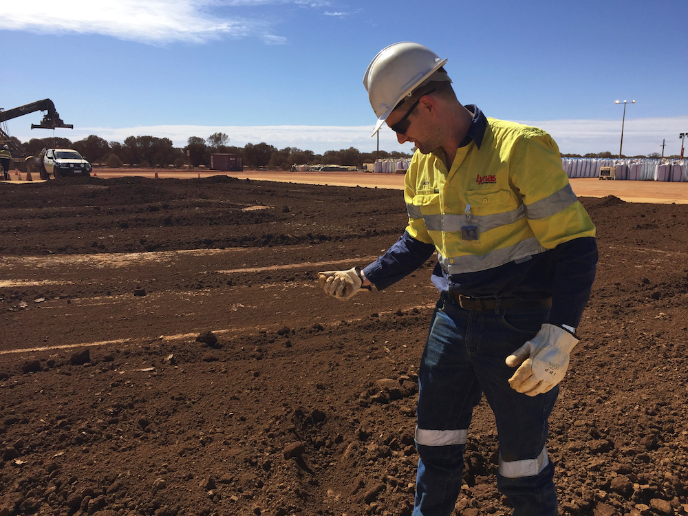 A worker picks up a handful of rare earth concentrate that has been left to dry in the sun before it is packed and shipped to Malaysia for further processing, at Mount Weld, northeast of Perth, August 23, 2019. u00e2u20acu201d Reuters pic