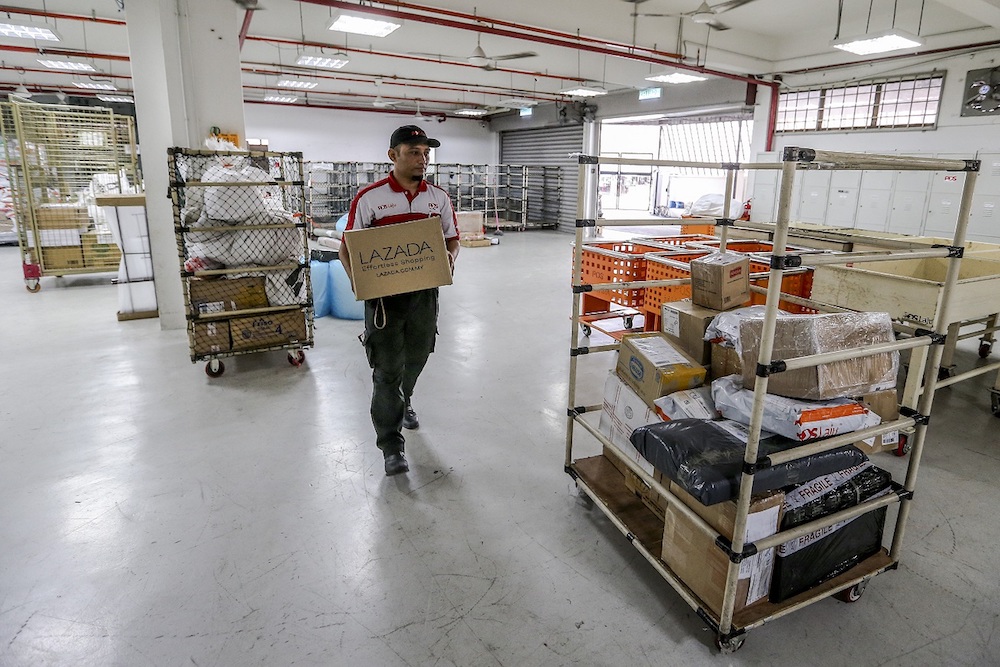 Yuzali sorts out 80 to 100 parcels from Integrated Parcel Centre (IPC), Shah Alam as early as 7am every day. — Picture by Firdaus Latif