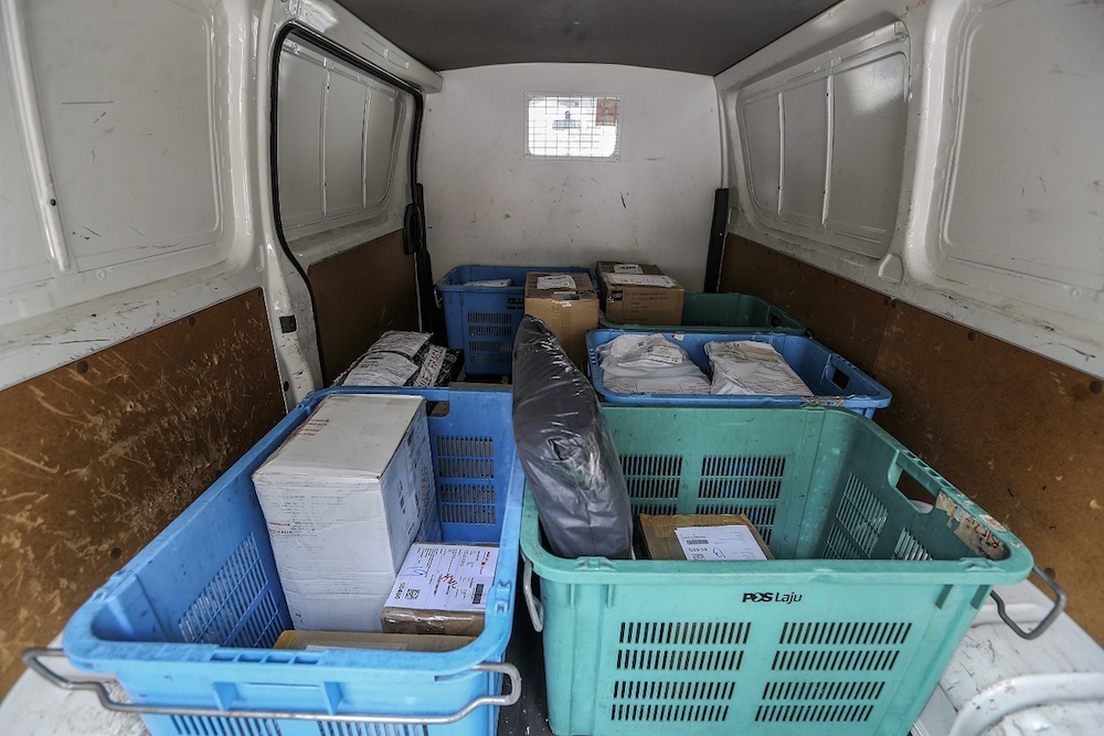 The packages get sorted again into their respective stations and zones. — Picture by Firdaus Latif