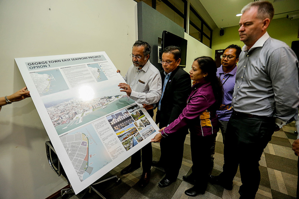Jagdeeo Singh Deo and Penang Port Commission chairman Jeffrey Chew (2nd left) look at an artistu00e2u20acu2122s impression of the East Seafront Project at Swettenham Pier in George Town August 1, 2019. u00e2u20acu201d Picture by Sayuti Zainudin