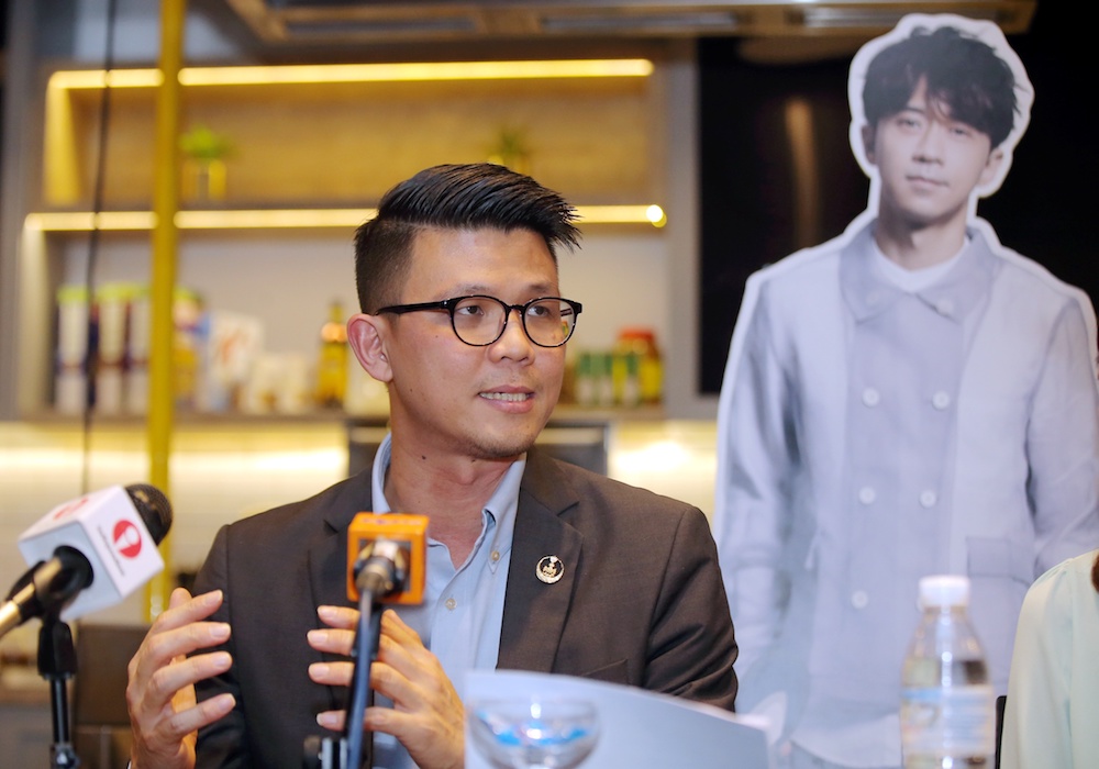 State Tourism and Culture Committee chairman Tan Kar Hing announces singer Michael Wongu00e2u20acu2122s appointment as the new Perak tourism ambassador in Ipoh August 2, 2019. u00e2u20acu201d Picture by Farhan Najib