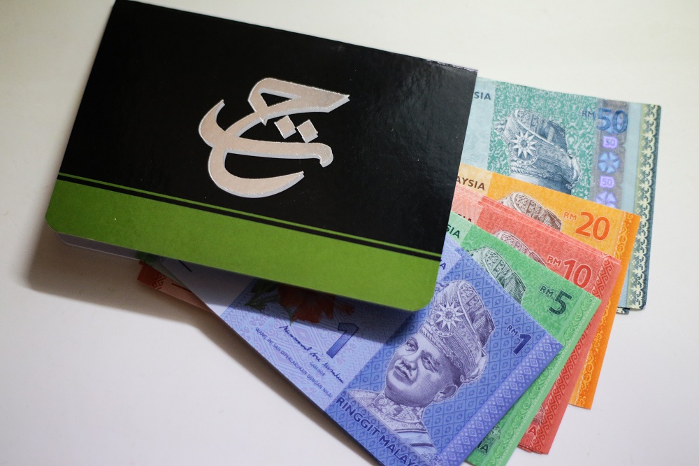 The Lembaga Tabung Haji logo is seen on a bank book in this photo taken in Kuala Lumpur August 4, 2019. u00e2u20acu201d Picture by Ahmad Zamzahuri