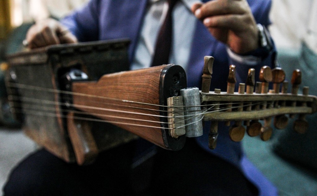 Iraqi musician Majed Abdennour plays a custom-built lute made from a Kalashnikov assault rifle and an ammunition box on August 9, 2019. u00e2u20acu201d AFP picnn