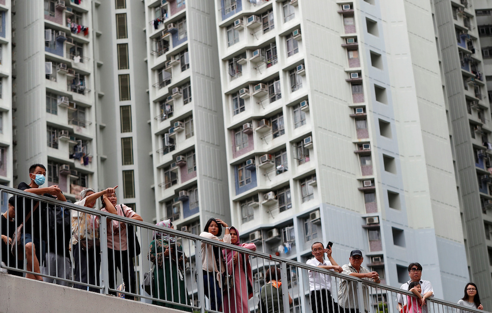 Local residents watch as anti-extradition bill protesters march through Sham Shui Po neighbourhood in Hong Kong  August 11, 2019. u00e2u20acu201d Reuters pic