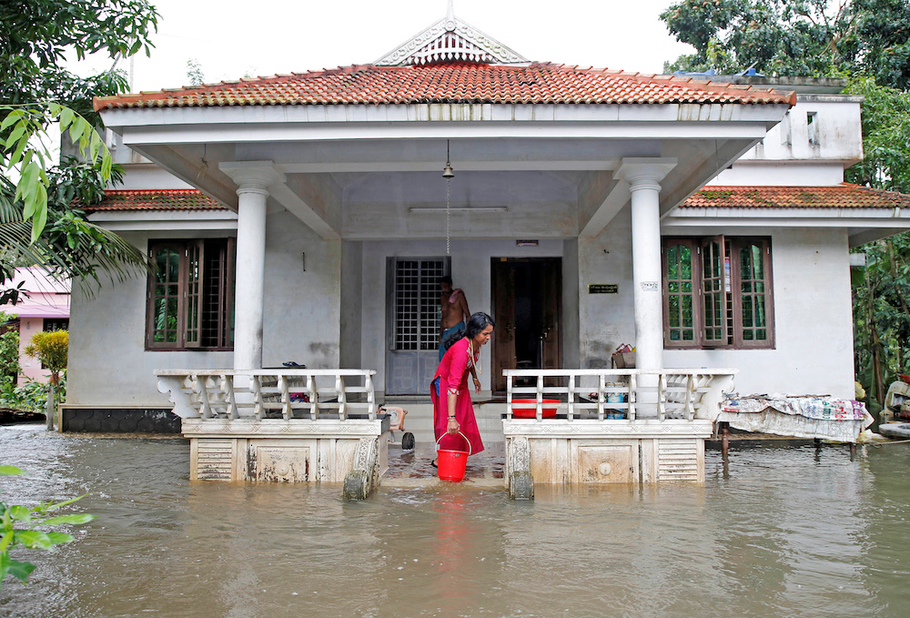A woman clears out the water from her flooded house at Paravur on the outskirts of Kochi, in the southern state of Kerala, India August 11, 2019. u00e2u20acu201d Reuters pic
