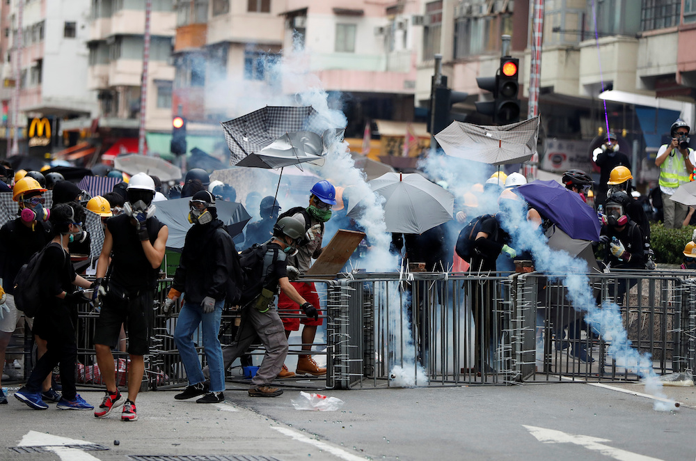 Anti-extradition bill protesters react after tear gas was fired by police, during a demonstration in Sham Shui Po neighbourhood in Hong Kong August 11, 2019. u00e2u20acu201d Reuters pic