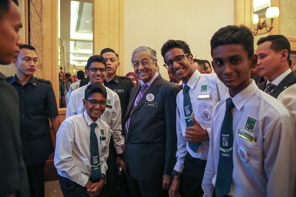 Prime Minister Tun Dr Mahathir Mohamad takes a photo with a group of students during the national civics education launch in Putrajaya August 13, 2019. u00e2u20acu201d Picture by Yusof Mat Isa