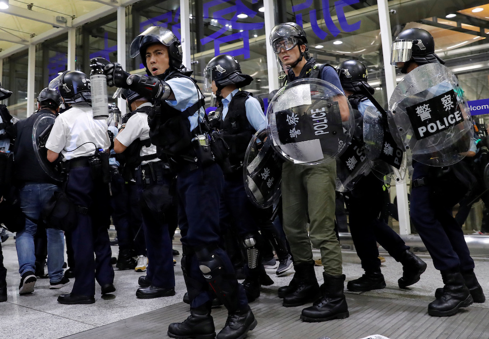 Riot police use pepper spray to disperse anti-extradition bill protesters during a mass demonstration after a woman was shot in the eye, at the Hong Kong international airport, in Hong Kong August 13, 2019. u00e2u20acu201d Reuters picnn