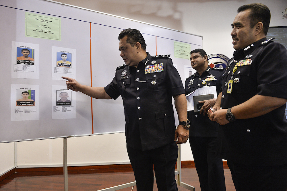 CID Director Datuk Huzir Mohamed points at the suspects’ mugshots during a press conference at the Selangor Contingent Police Headquarters in Shah Alam August 15, 2019. — Picture by Miera Zulyana