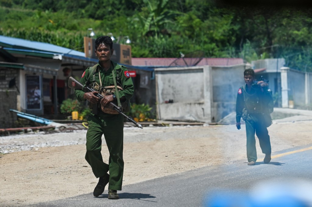 This photo taken on August 25, 2019 shows Myanmar soldiers walking along the Pyidaungsu highway road outside Kutkai in Shan State. u00e2u20acu201d AFP pic nn