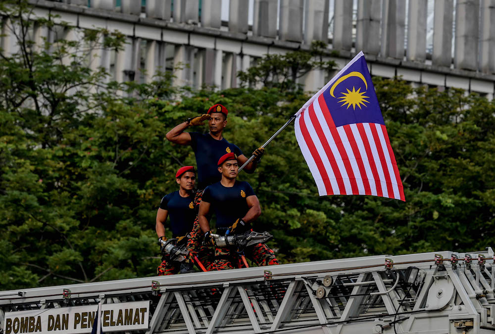 Fire and Rescue Department personnel march during a National Day rehearsal in Putrajaya August 29, 2019. u00e2u20acu201d Picture by Firdaus Latif