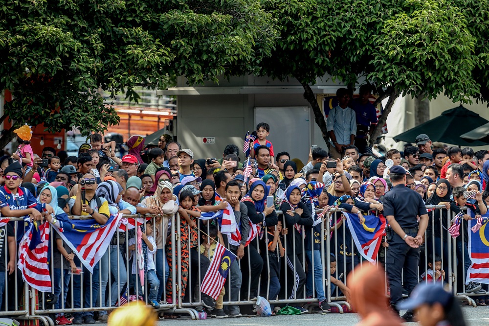 Spectators watch as soldiers march in formation during the National Day celebrations at Dataran Putrajaya August 31, 2019. u00e2u20acu201d Picture by Firdaus Latif