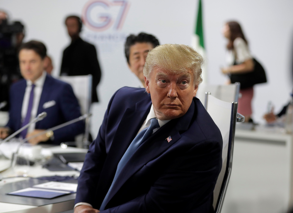 President Donald Trump looks around as photographers take photos ahead of a working session on World Economy and Trade on the second day of the G-7 summit in Biarritz August 25, 2019.u00e2u20acu201d Markus Schreiber/Pool handout via Reuters