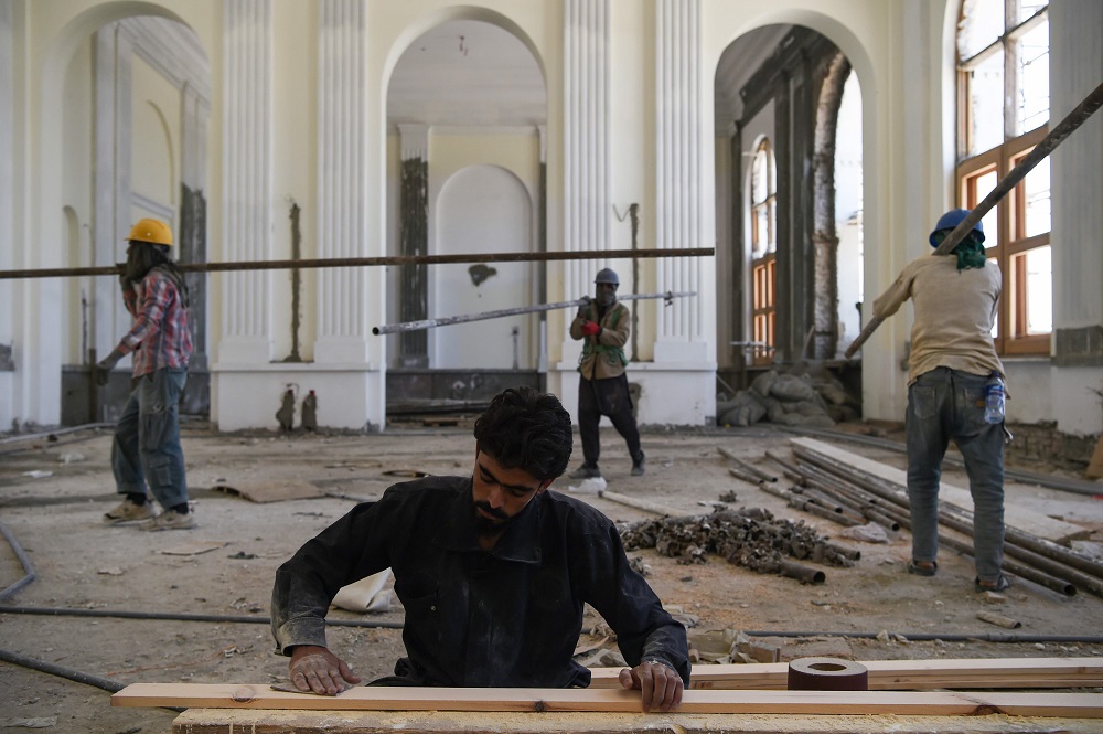 In this photo taken on August 1, 2019 Afghan labourers work on the renovation of Darulaman Palace in Kabul. — AFP pic           