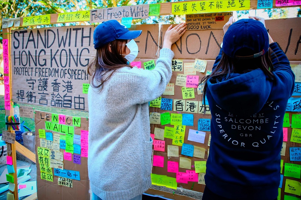 Supporters of the Hong Kong pro-democracy protests posting notes on a makeshift u00e2u20acu02dcLennon Wallu00e2u20acu2122 at the University of Queensland in Brisbane August 9, 2019. u00e2u20acu201d AFP pic