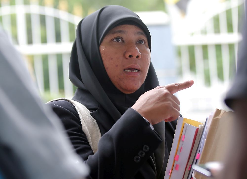 Lawyer Asiah Abd Jalil speaks to reporters outside the Magistrateu00e2u20acu2122s Court in Ipoh August 7, 2019. u00e2u20acu2022 Picture by Farhan Najib