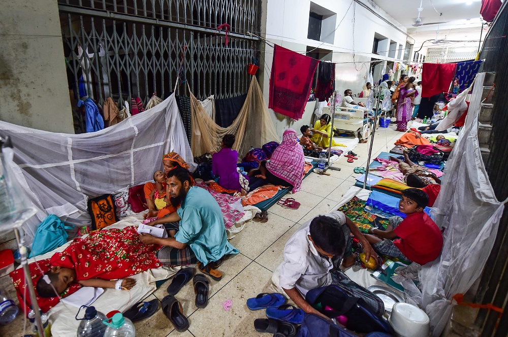 This photograph taken on August 4, 2019, shows Bangladeshi children suffering from dengue fever and their relatives as they receive treatment in beds on the floor of a ward at the Shaheed Suhrawardy Medical College and Hospital in Dhaka. u00e2u20acu201d AFP pic      