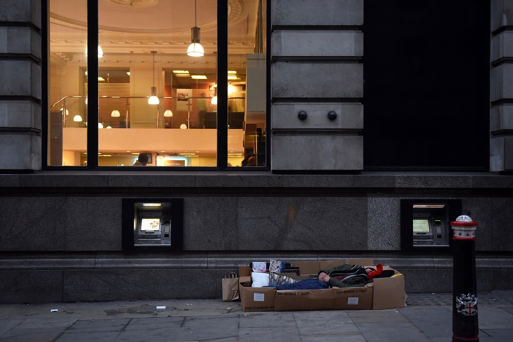A homeless man sleeps in the cardboard box where he lives, outside Barclays Bank on Fleet Street in London December 19, 2017. u00e2u20acu201d Reuters pic
