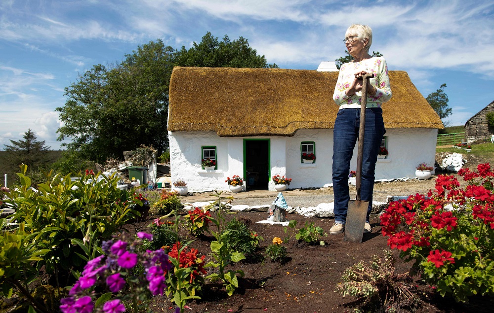 Margaret Gallagher, 77, poses for a photograph in her garden in front of her three roomed thatched cottage near the village of Belcoo, Enniskillen, northern Ireland, on the border with the Republic of Ireland, July 15, 2019. u00e2u20acu201d AFP pic 