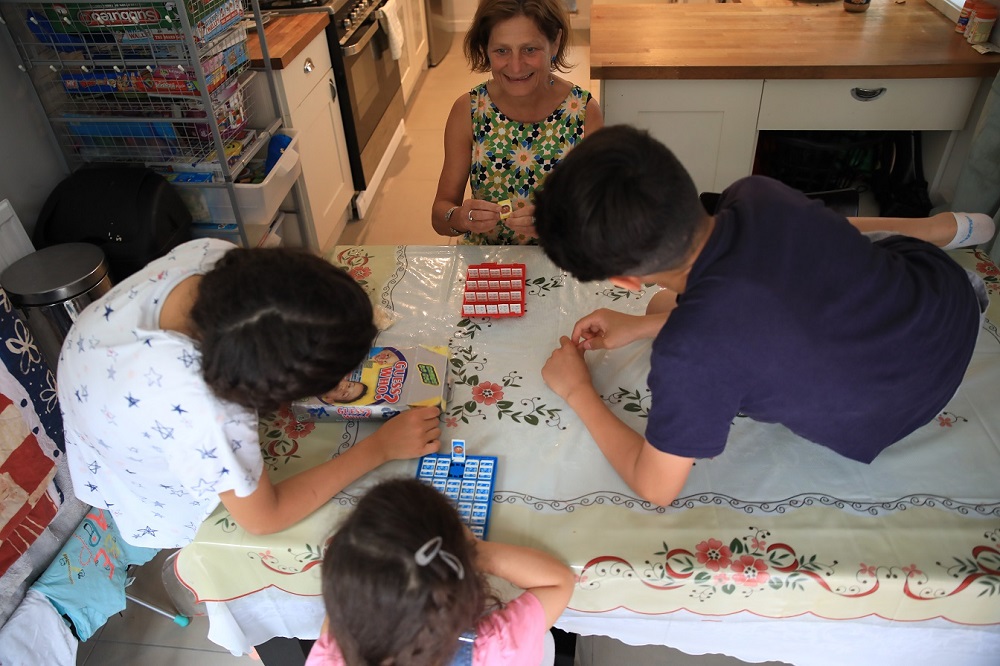 Harriet Lamb (centre), who is part of a south London community group that privately sponsors refugees, plays a game with Iraqi refugee children whom she helped resettle into the country, in London July 30, 2019. u00e2u20acu201d Thomson Reuters Foundation pic