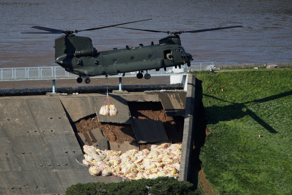 A Chinook helicopter drops sand bags on top of the dam after a nearby reservoir was damaged by flooding, in Whaley Bridge, Britain August 2, 2019. u00e2u20acu201d Reuters pic 