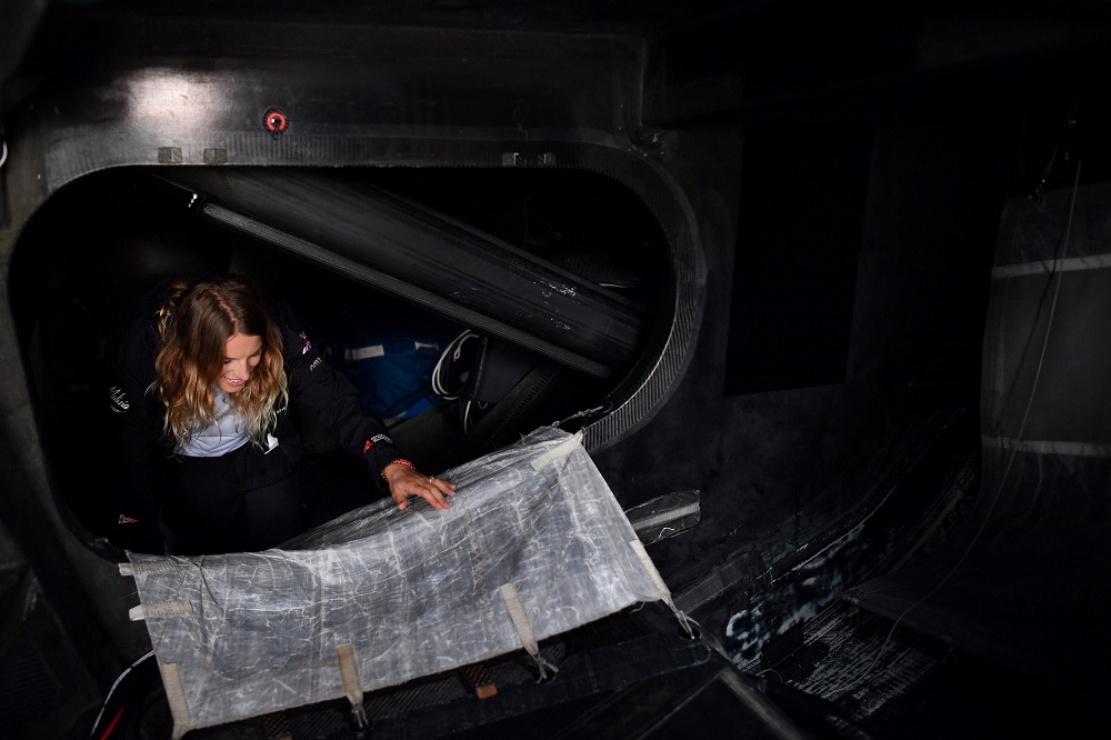 A crew member climbs from a sleeping area onboard the Malizia II sailing yacht in Plymouth, southwest England, on August 13, 2019 ahead of a journey across the Atlantic to New York carrying Swedish climate activist Greta Thunberg as a passenger. u00e2u20acu201d AFP p