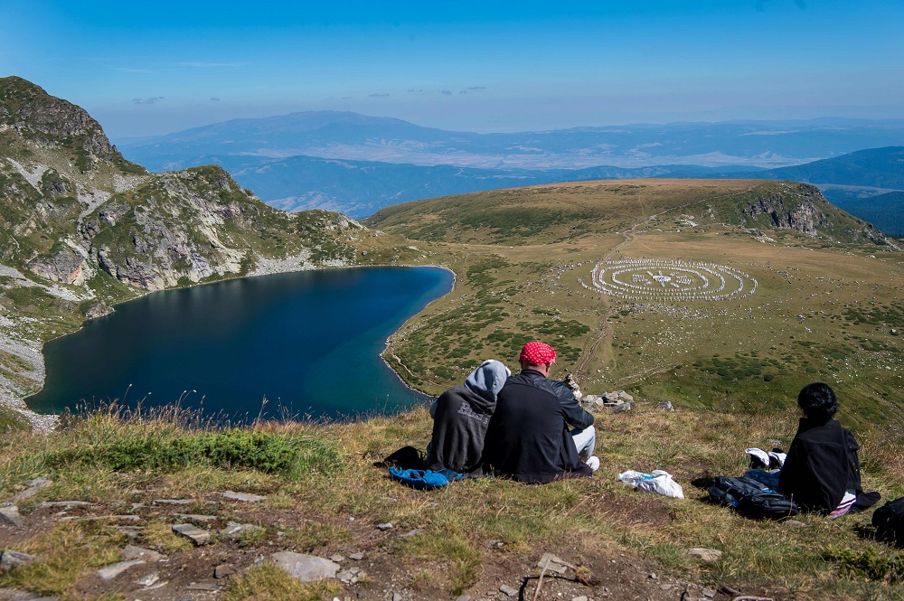 People watch members of an international religious movement called the Universal White Brotherhood performing a ritual dance on the top of the Rila Mountain, near Babreka lake, Bulgaria August 19, 2019. — AFP pic  