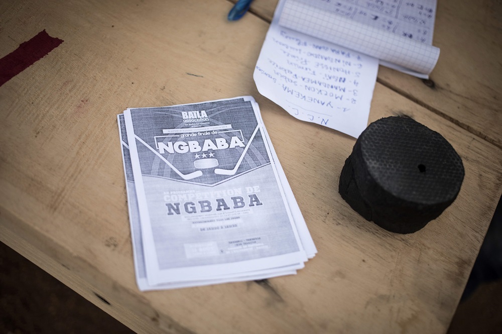 This picture shows a puck and flyers of a Ngbaba game on the table of the Ngbaba arbitrator in Bangui August 8, 2019. — AFP pic