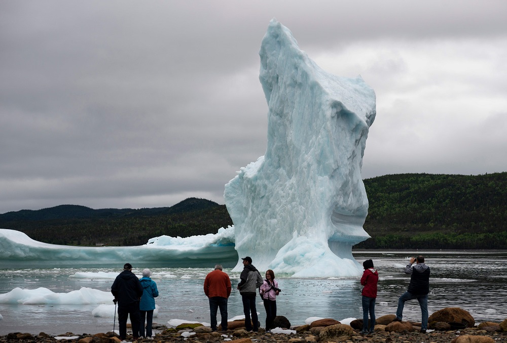 Tourists look at icebergs from the seashore of Kingu00e2u20acu2122s Point in Newfoundland, Canada July 3, 2019. u00e2u20acu201d AFP pic          