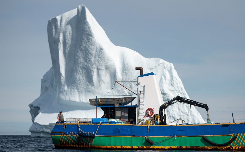 Captain Edward Kean stands on his boat in front of an iceberg in Bonavista Bay in Newfoundland, Canada June 29, 2019. u00e2u20acu201d AFP pic       