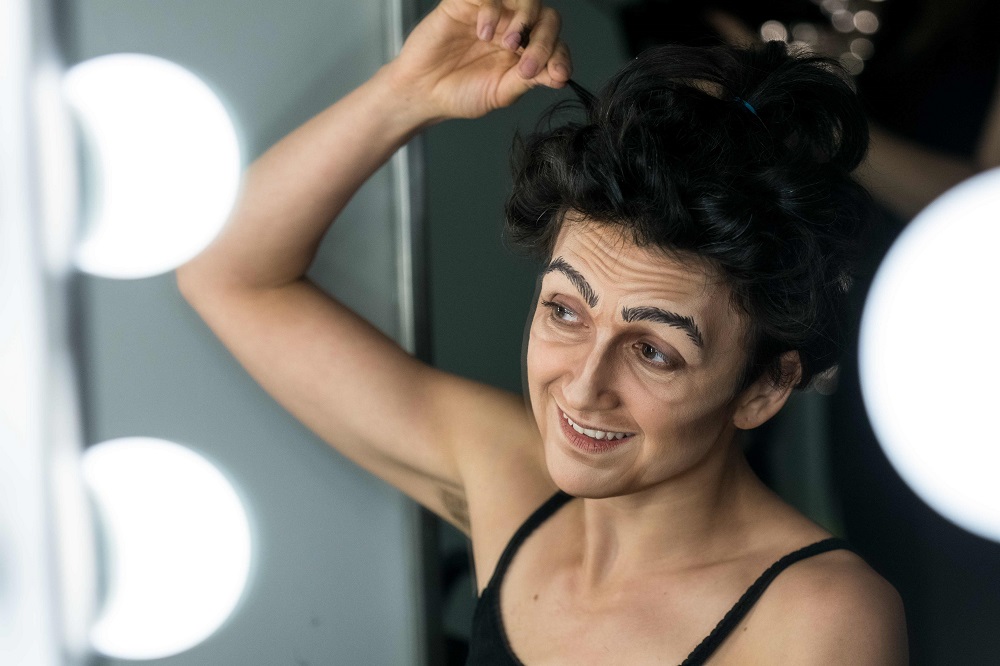 In this file photo taken on July 12, 2019, Melodie Rousseau works on her hair before her Drag King performance in Montreal, Canada. — AFP pic