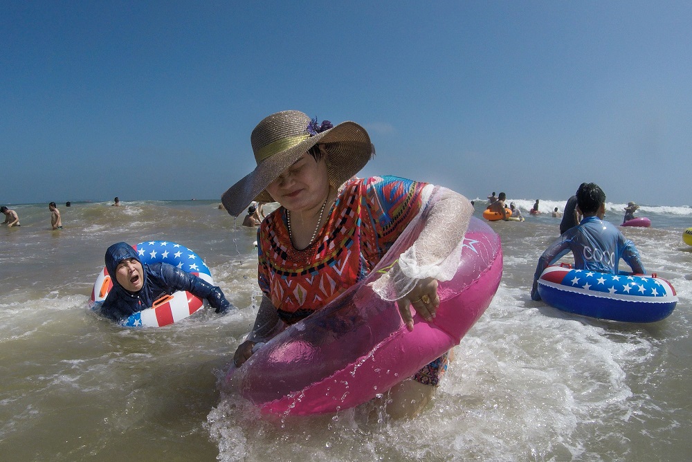 People cool themselves on a beach in Qingdao, eastern Chinau00e2u20acu2122s Shandong province on August 3, 2019. u00e2u20acu201d AFP pic         