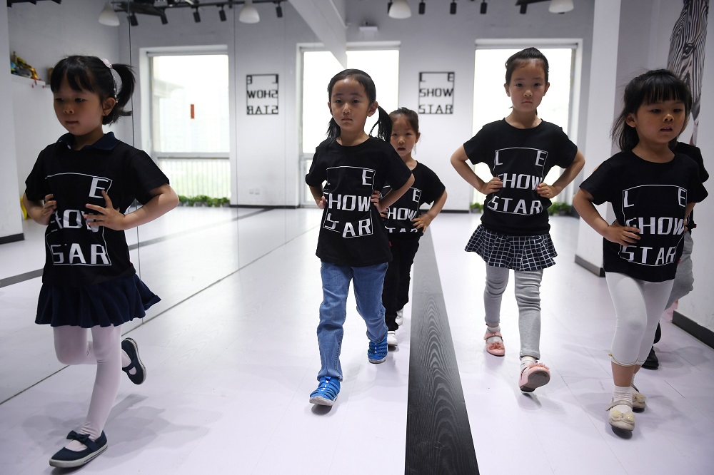 This photo taken on May 11, 2019 shows children training at a modelling school in Beijing. u00e2u20acu201d AFP pic  