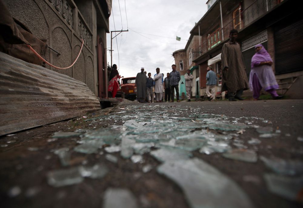 Kashmiris walk past broken window glass after clashes between protesters and the security forces, during restrictions following the scrapping of the special constitutional status for Kashmir by the Indian government, Srinagar, Aug 17, 2019. u00e2u20acu201d Reuters pi