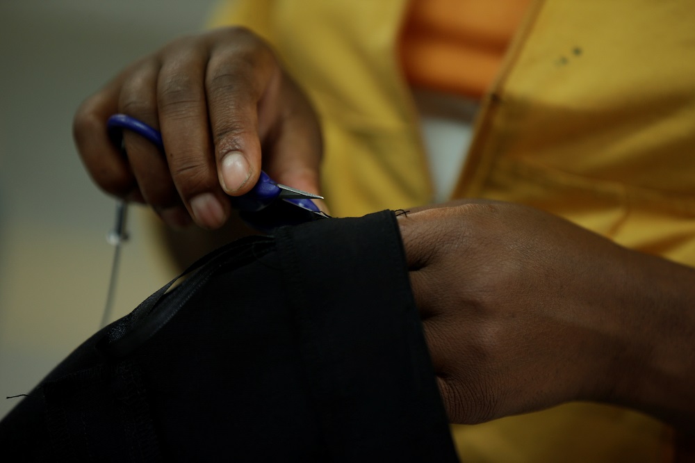 A worker removes excess threads on a finished garment in a textile factory in Ethiopia November 17, 2017. u00e2u20acu201d Reuters pic   