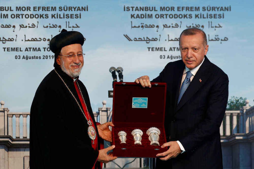 Turkish President Tayyip Erdogan receives a present from Yusuf Cetin, the Syriac Orthodox Churchu00c3u2022s metropolitan for Istanbul and Ankara,u00c3u0160during the groundbreaking ceremony of the Mor Efrem Syriac Orthodox Church in Istanbul, Turkey, August 3, 2019. u00e2u20acu201d 