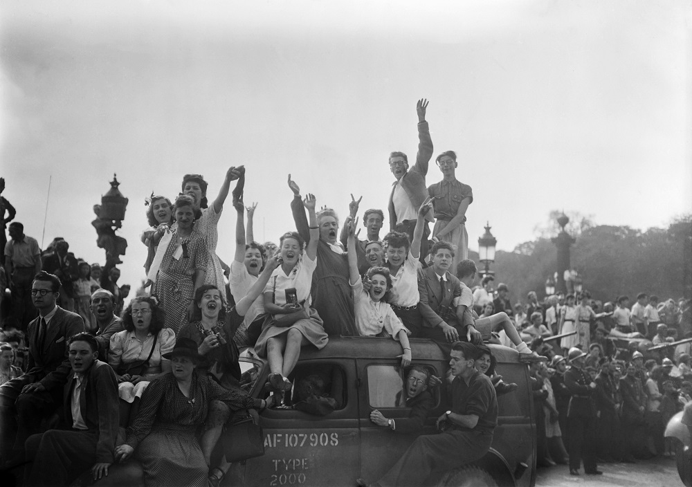 In this August 26, 1944 photo, a cheering crowd salutes as they wait for soldiers of the Allied troops and the French 2nd armoured division on the Place de la Concorde in Paris, during the parade to celebrate the Liberation of Paris, during WWII. u00e2u20acu201d AFP 