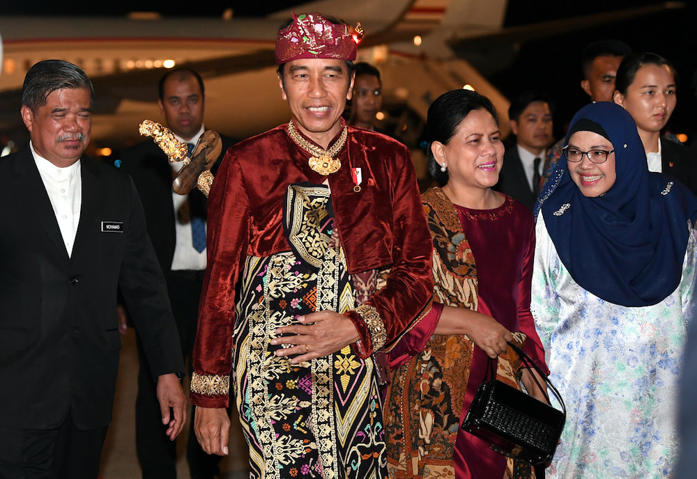 Indonesian President Joko Widodo and his wife Iriana Joko Widodo are greeted by Defence Minister Mohamad Sabu and his wife Normah Alwi after touching down at KLIA in Sepang August 8, 2019. u00e2u20acu201d Bernama pic