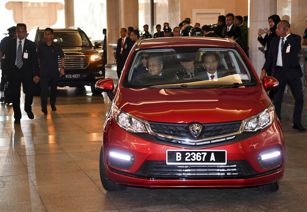 Prime Minister Tun Dr Mahathir Mohamad drives Indonesian President Joko Widodo to lunch at Seri Perdana in Putrajaya August 9, 2019. u00e2u20acu201d Bernama pic