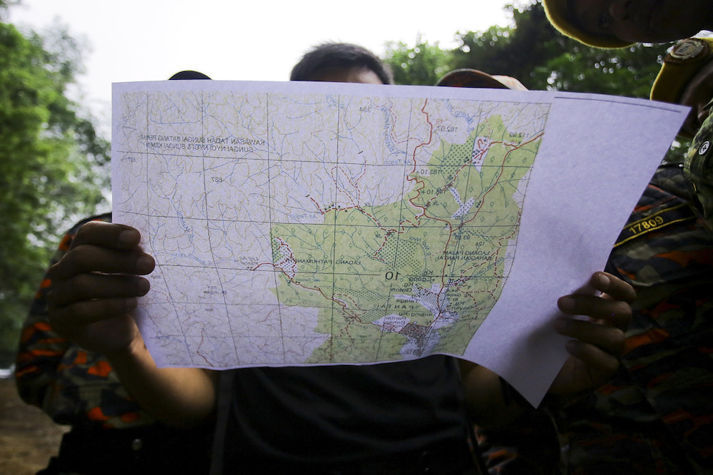 A member of a Malaysian rescue team takes part in a search and rescue operation in a forest for the missing 15-year-old Franco-Irish girl Nora Anne Quoirin in Seremban August 9, 2019. u00e2u20acu201d Bernama pic