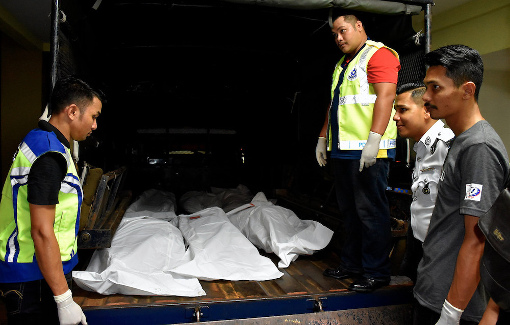 The bodies of four victims of the fatal crash along the Alor Gajah-Melaka-Jasin Expressway (Lebuh AMJ) heading to Simpang Ampat are loaded onto a police truck at Alor Gajah Hospital August 10, 2019. u00e2u20acu201d Bernama pic