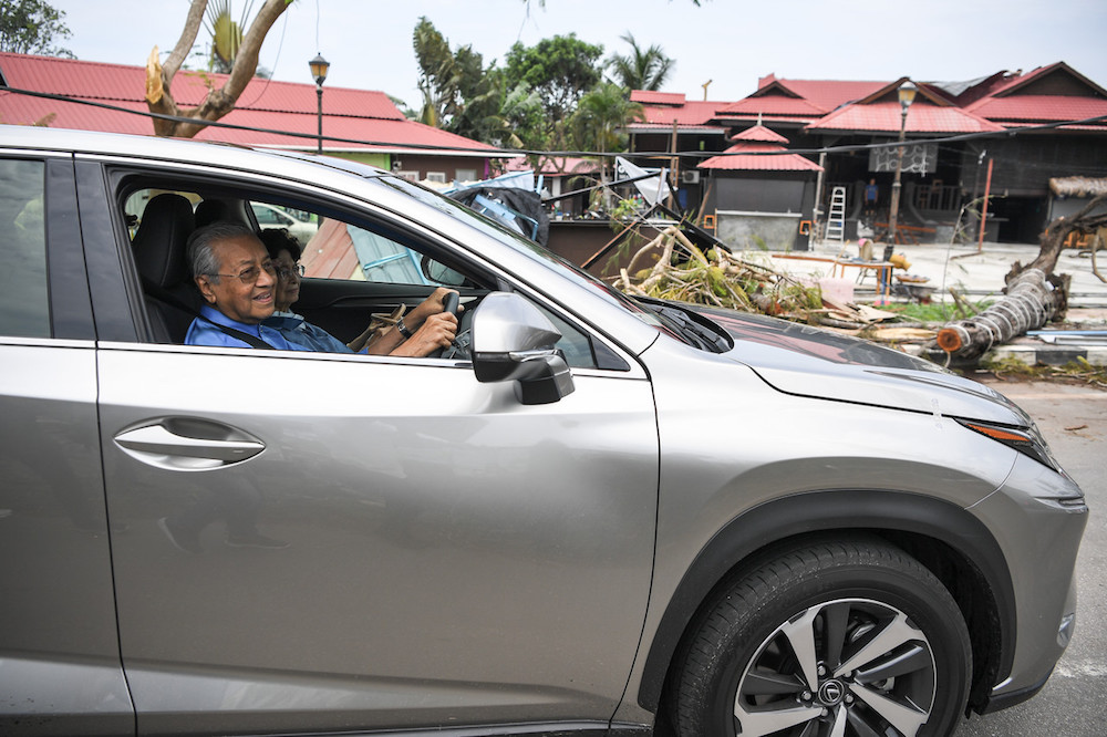 Prime Minister Tun Dr Mahathir Mohamad and his wife Tun Dr Siti Hasmah Mohd Ali visit Pantai Tengah in Langkawi August 12, 2019, in the aftermath of a storm caused by Typhoon Lekima on August 9. u00e2u20acu201d Bernama pic