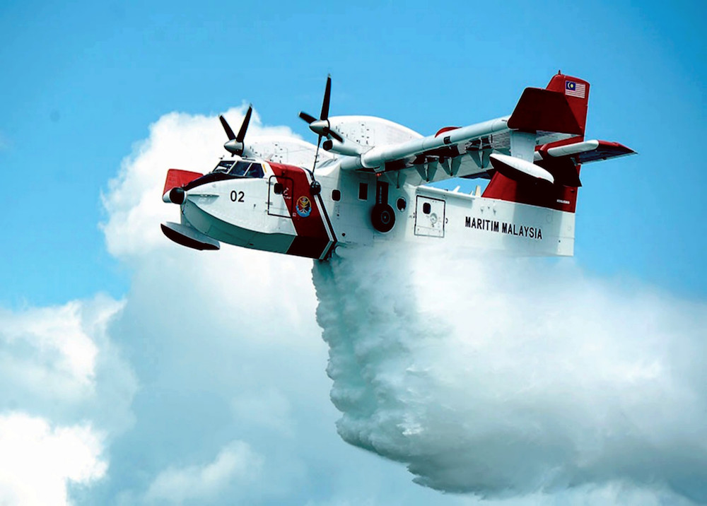 A Malaysian Maritime Enforcement Agency (MMEA) Bombardier CL415 aircraft conducts a water bombing exercise in Kuala Baram, Miri August 14, 2019. u00e2u20acu201d Bernama pic