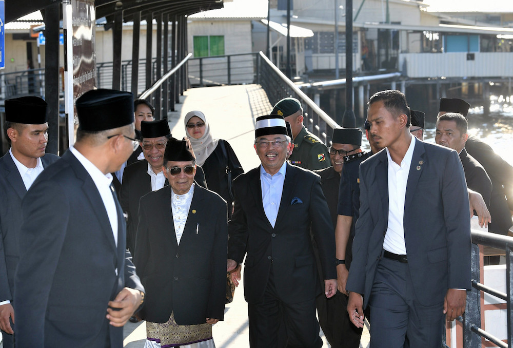 Sultan Abdullah Ahmad Shah is greeted by Kampong Ayer village chief, Ahmad Bujang, during a visit to the settlement in Bandar Seri Begawan August 19, 2019. u00e2u20acu201d Bernama pic