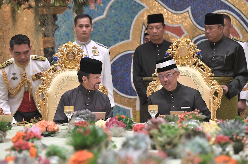 Sultan of Brunei, Sultan Hassanal Bolkiah and Yang di-Pertuan Agong Al-Sultan Abdullah Ri'ayatuddin Al-Mustafa Billah Shah chat during a banquet at Nurul Iman Palace in Bandar Seri Begawan August 19, 2019. u00e2u20acu201d Bernama pic