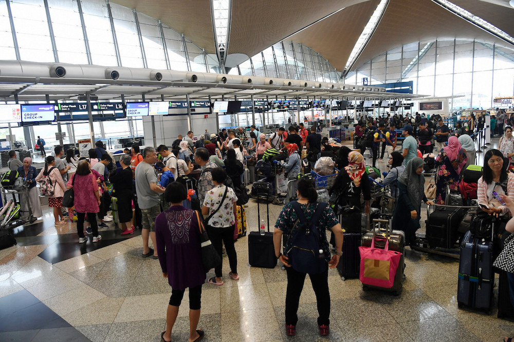 Passengers are seen at KLIA in Sepang August 22, 2019, during a systems outage. — Bernama pic