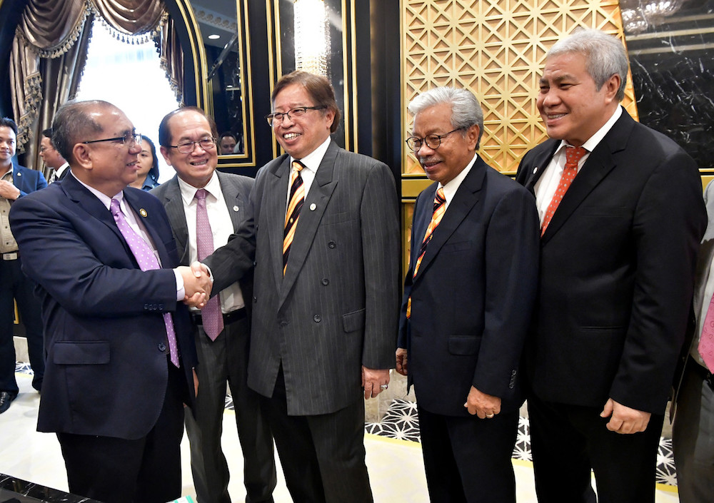 Sarawak Chief Minister Datuk Patinggi Abang Johari Openg shakes hands with Datuk Jaul Samion in Kuching August 22, 2019, following his appointment as Sarawak state secretary. u00e2u20acu201d Bernama pic